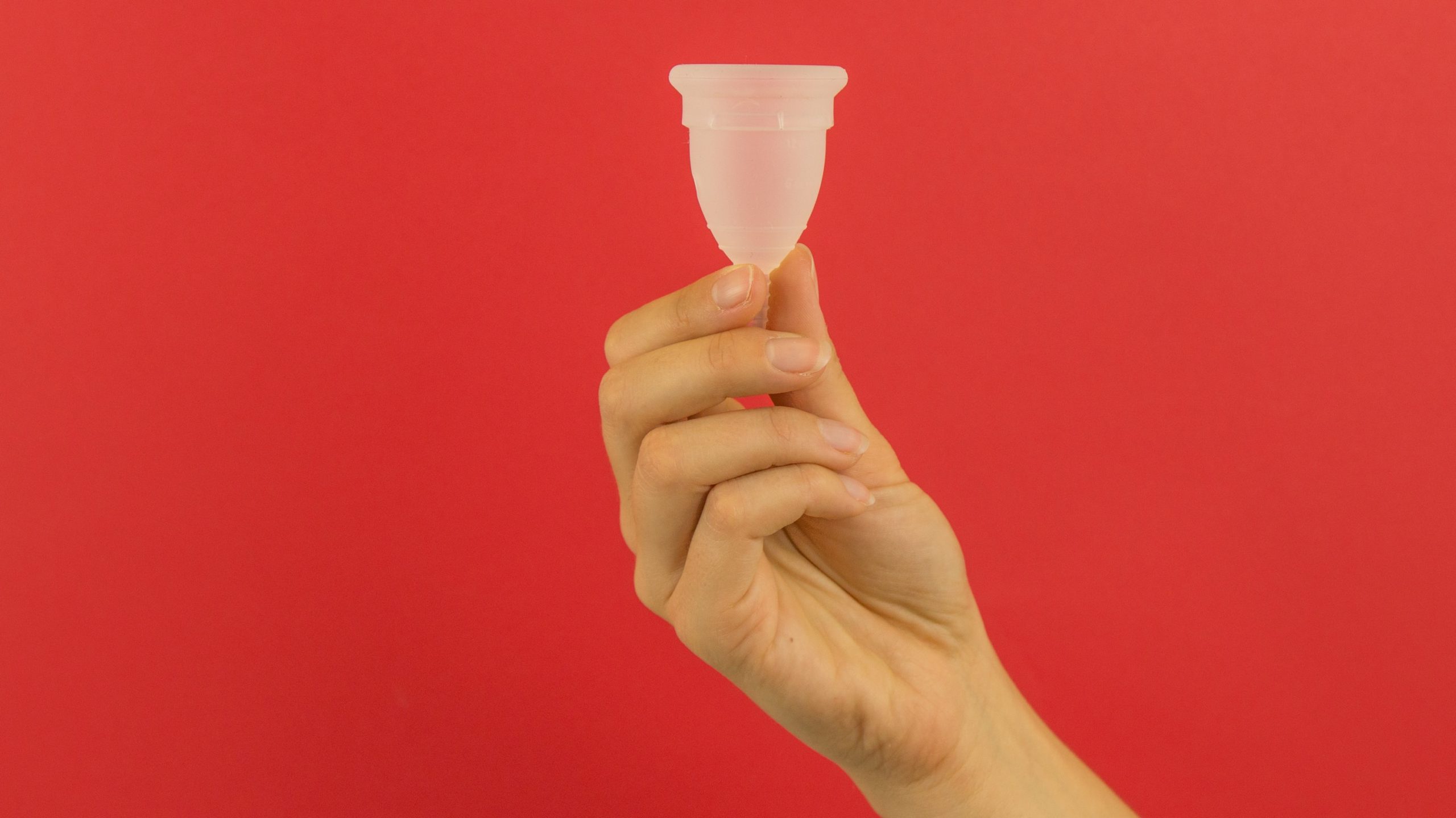 menstrual cup, red background